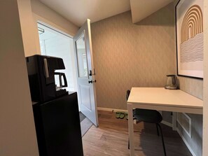 A compact kitchen with a refrigerator, coffee maker, and a small table with a kettle. - Private Room With Own Entrance (Surrey)