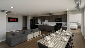 A modern apartment with a living room, dining area, kitchenette, and a bedroom. - Elegant 2BR Apartment with Fast WiFi & Free Parking (Des Moines)