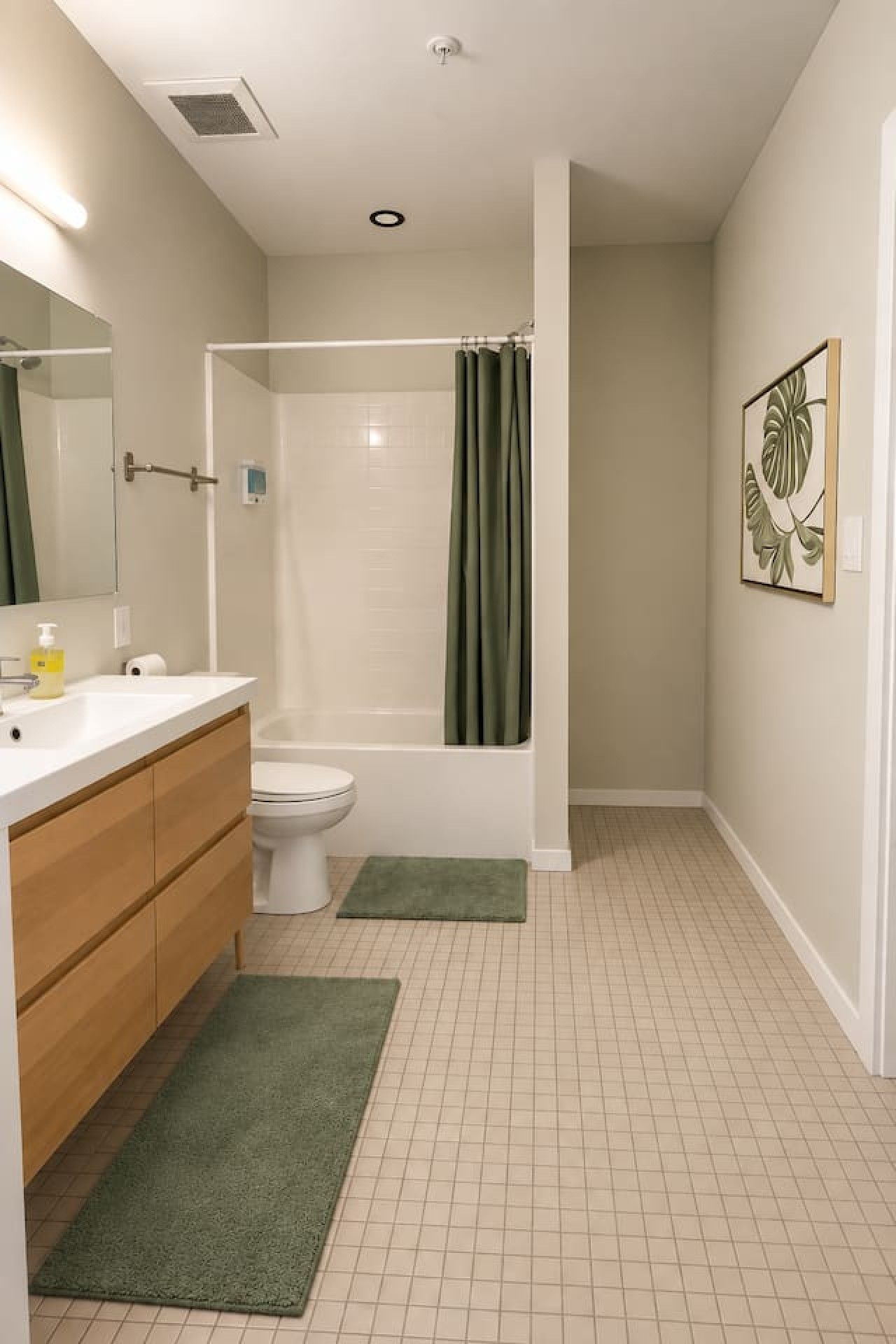 A bathroom with a shower, toilet, and sink.