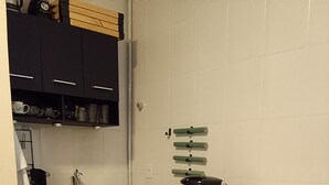 A compact kitchen with a microwave, kettle, and small refrigerator. - Cozy studio in Glória, close to the Lapa arches and Glória metro station. (Rio de Janeiro)