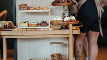 A bakery display with pastries and a coffee machine in the background.