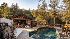 A pool area with a hot tub, wooden deck, and outdoor seating. - Prime Sequoia Stay: Pool • Hot Tub • Sauna • Views (Three Rivers)