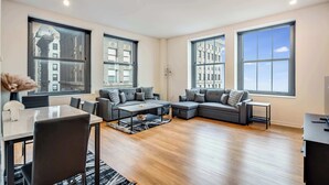 A spacious living room with a dining area, large windows, and a modern design. - Downtown Chicago Stay with Free In & Out Parking 1 (Chicago)