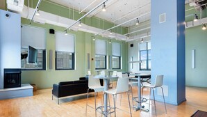 A modern interior with a wooden floor, a fireplace, a seating area, and a bar with stools. - Downtown Chicago Stay with Free In & Out Parking 6 (Chicago)