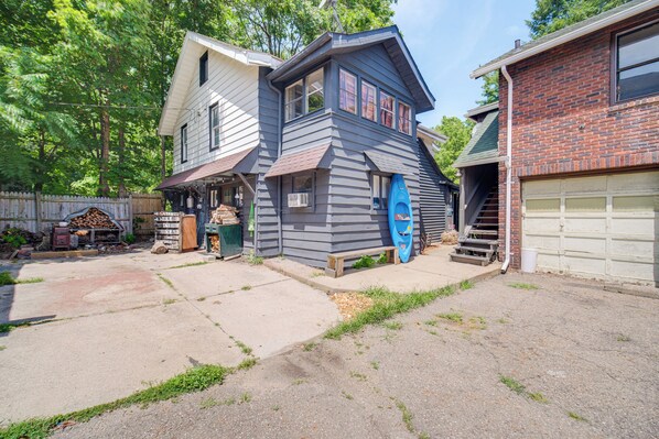 A two-story house with a garage, a front porch, and a blue kayak.