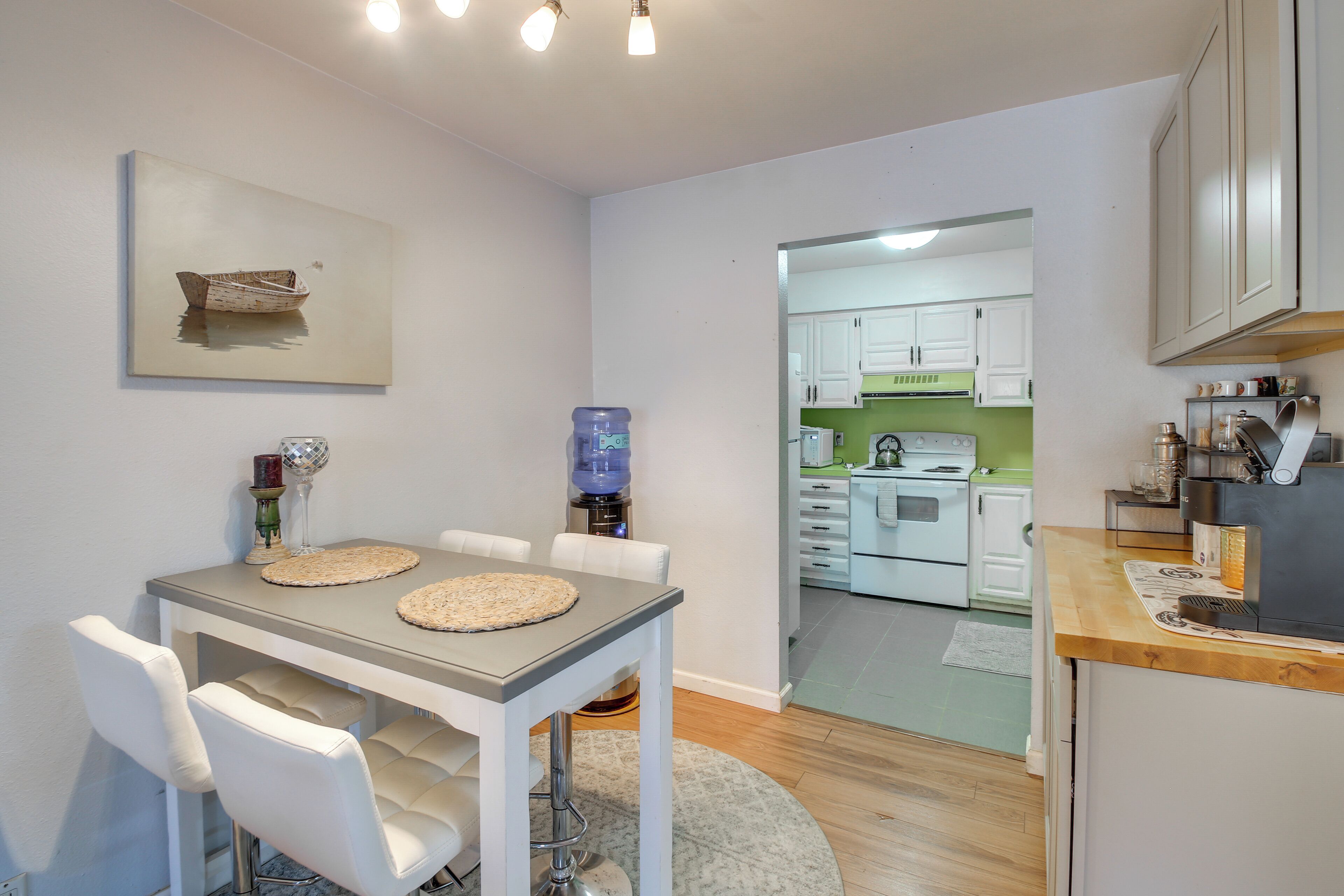 A dining area with a table, chairs, and a water dispenser.