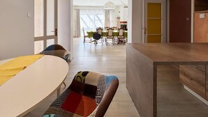 A modern living room with a dining area, featuring a sofa, a coffee table, and a wooden cabinet. - Awesome home in Liznjan (Liznjan)