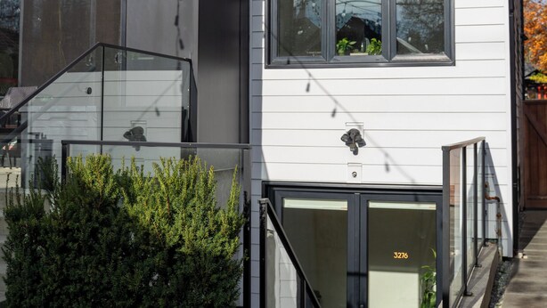 A modern two-story building with a flat roof, large windows, and a visible address number. - Bright & Cozy Kitsilano Suite | Walk to Beach (Vancouver)