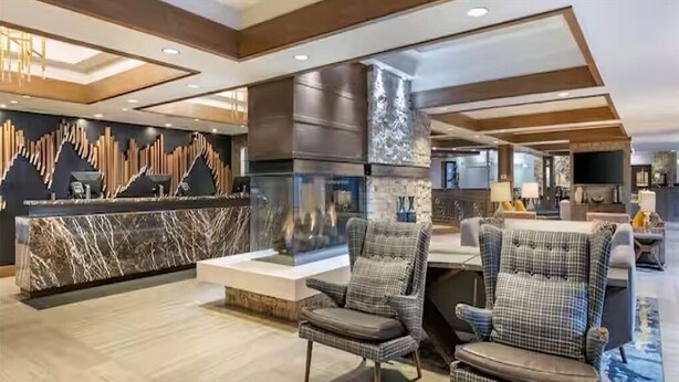 A modern lobby with a marble reception desk, check-in counters, and seating areas with patterned chairs. - 2 bedroom unit, sleeps 6 for Christmas week across Heavenly Valley Ski Resort (South Lake Tahoe)