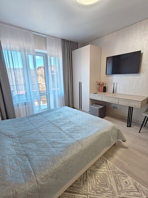 Apartment, Balcony, Mountain View | Desk, laptop workspace, blackout curtains, iron/ironing board