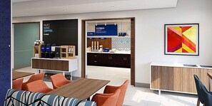 A modern hotel lobby with a coffee station, seating area, and a large abstract painting. - Holiday Inn Express Plainwell by IHG (Plainwell)
