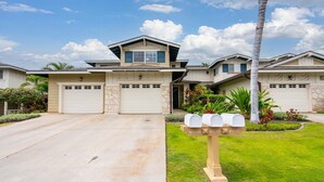 A modern two-story house with a garage, a driveway, and a well-maintained lawn. - Your Resort Home! Walk to Disney & Beach! (Kapolei)