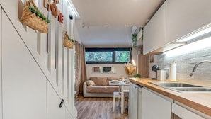 A compact kitchen with a dining area, featuring a wooden countertop, a sink, and a window with a view. - Awesome home in Meschers-sur-Gironde with WiFi (Meschers-sur-Gironde)
