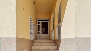 A staircase leading to a door with a view of a room with a bed and a window. - Lucia House - By Y Concept (Setúbal)