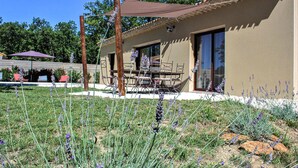 A building with a patio area, outdoor seating, and a pergola. - Nice home in Grignan with private swimming pool, can be inside or outside (Grignan)