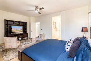 A bedroom with a bed, a TV, a chair, and a ceiling fan. - Indio 4BR Golf Course Oasis. Private Saltwater Pool, Spa & Casita (Indio)