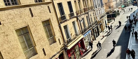 A street view with buildings, shops, and pedestrians.
