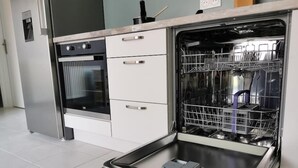 A kitchen with a built-in dishwasher, oven, and a microwave. - House with 5 bedrooms and 3 bathrooms | 1 bed 160cm & 4 beds 120cm (Etampes sur marne)