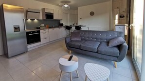 A modern apartment with a grey sofa, a small round table, and a white table. - House with 5 bedrooms and 3 bathrooms | 1 bed 160cm & 4 beds 120cm (Etampes sur marne)