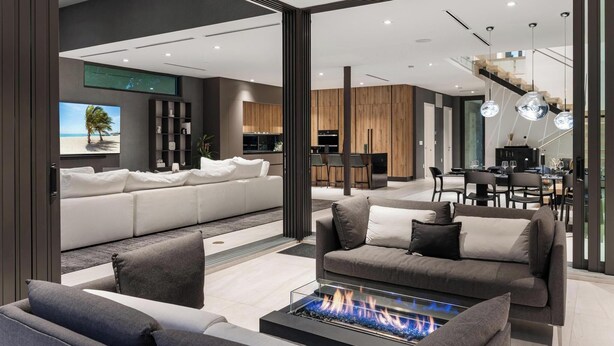 A modern living room with a fireplace, a sofa set, and a dining area. - Villa Strata: Modern 5 BED +POOL, minutes from The Grove, Brickell & Downtown (Miami)