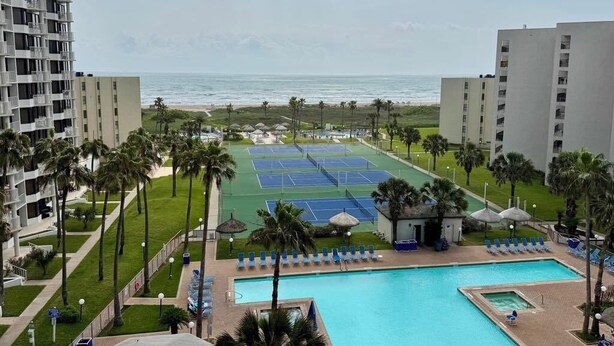 A hotel with a pool, tennis courts, and a view of the beach. - Saida III Condos - S3706 (South Padre Island)