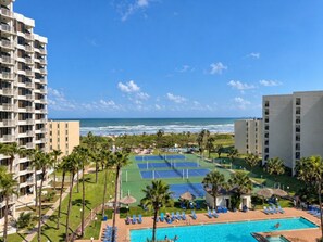 A hotel with a pool, tennis courts, and a view of the ocean. - Saida III Condos - S3706 (South Padre Island)