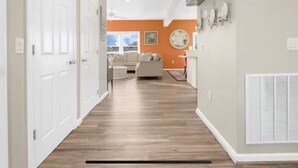 A hallway with a sofa and a fireplace. - Bayside Park Villa at Robin Drive (Ocean City)