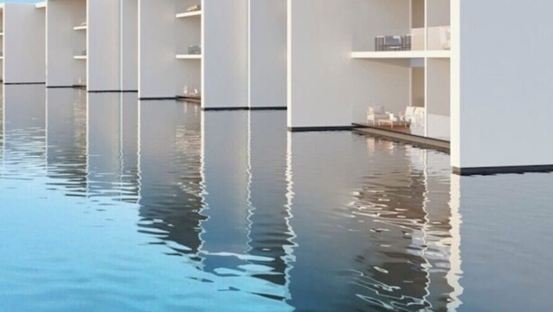 A modern building with multiple white balconies over a reflective water surface. - Beautiful New Luxury Apartment - Cora Sunset at Campestre (San Jose Del Cabo)