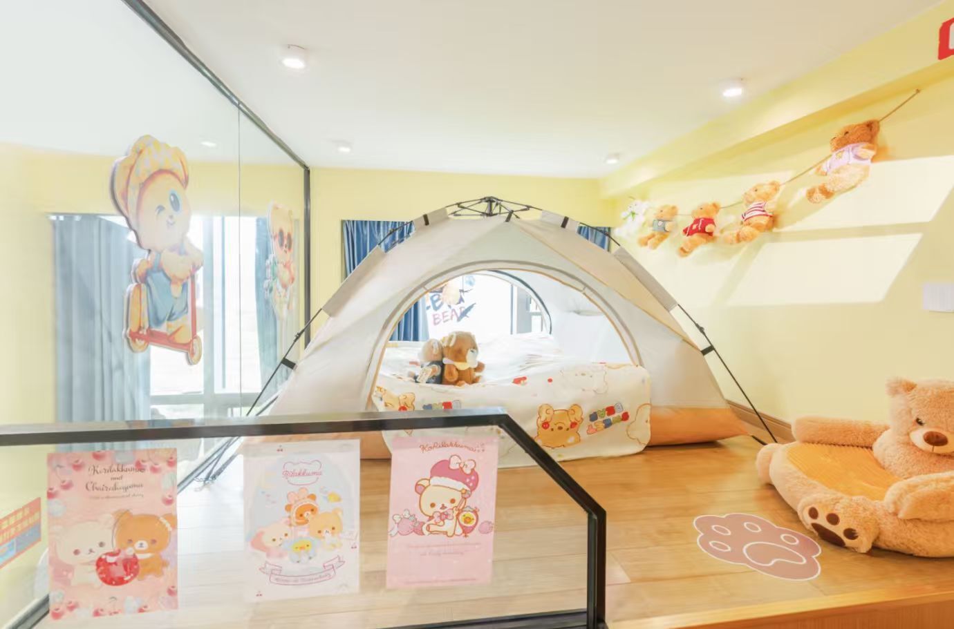 A children's play area with a tent, stuffed animals, and a mirror reflecting the room.