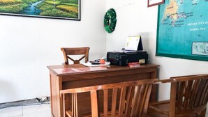 A wooden desk with a chair, a map on the wall, and a small Christmas wreath. - Cahaya Adrian Near Komodo Airport (Labuan Bajo)