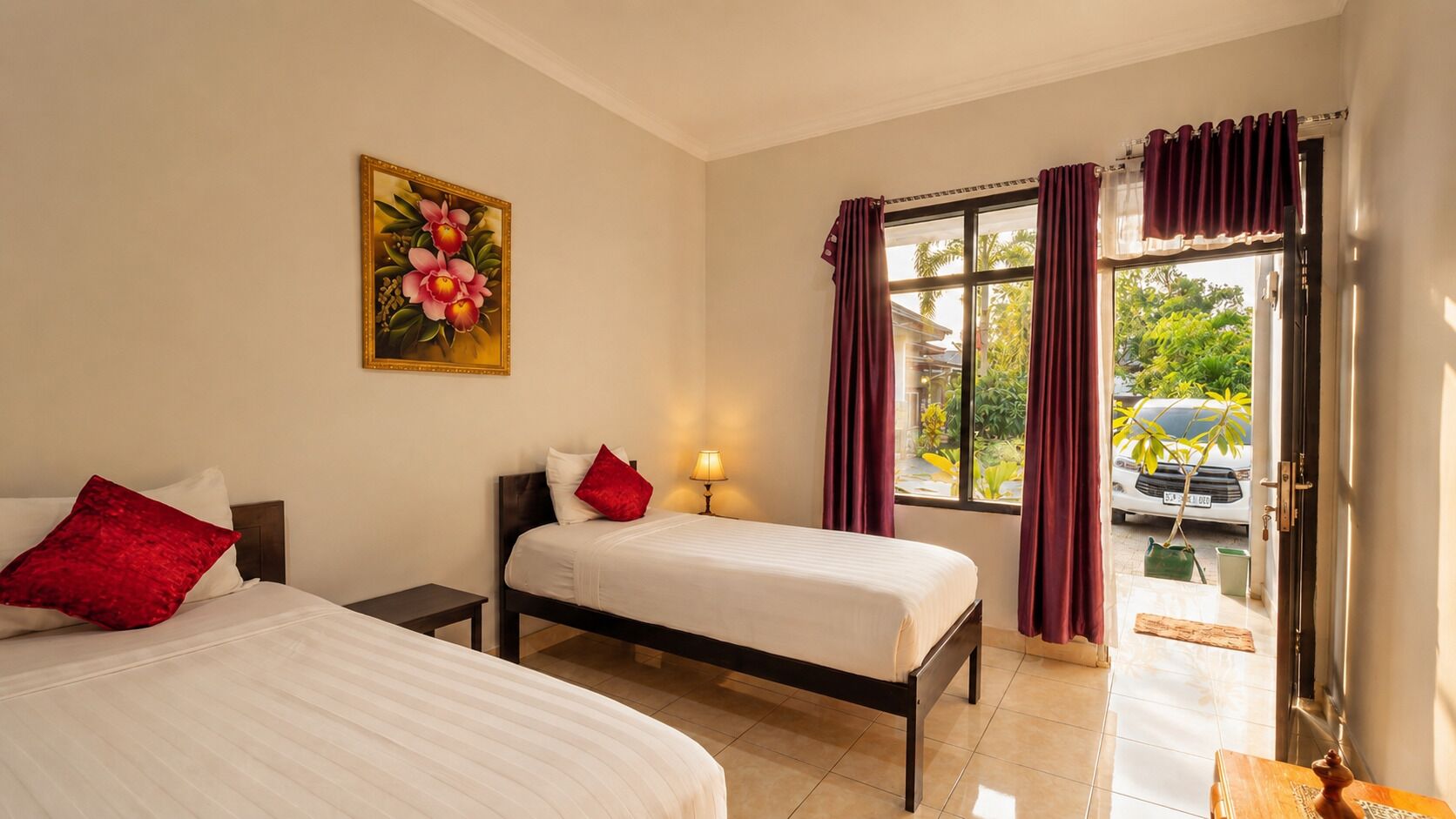A hotel room with two beds, a painting, a window with curtains, and a view of the outside.