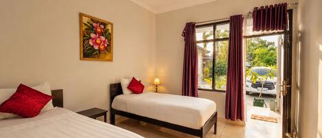 A hotel room with two beds, a painting, a window with curtains, and a view of the outside.