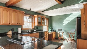 A kitchen with wooden cabinets, a granite countertop, and a refrigerator. - Designer | Hot Tub | Gameroom | Firepit | Sleeps12 (Banner Elk)