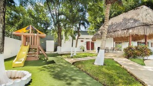 A children's play area with a slide and a wooden play structure.