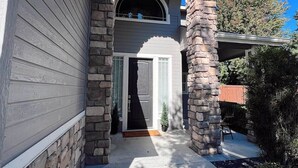 A house with a stone archway entrance, a covered porch, and a small front yard with a potted plant. - Reed's Ranch House In Star (Star)