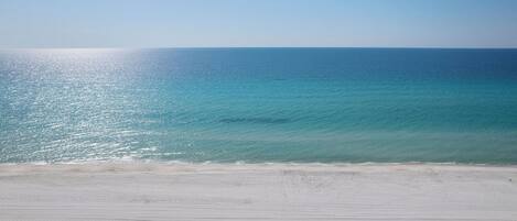 A beach with a clear sky and calm sea.