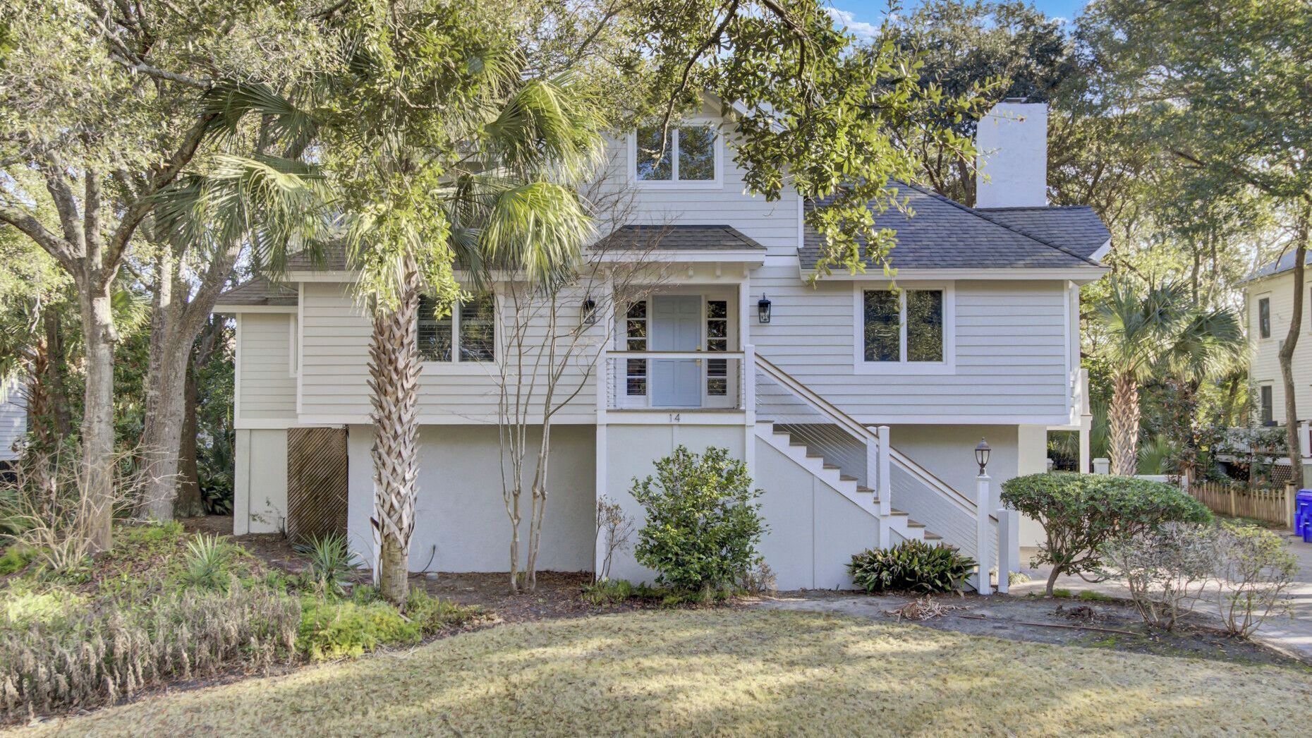 A two-story house with a front porch, a staircase, and a small front yard.