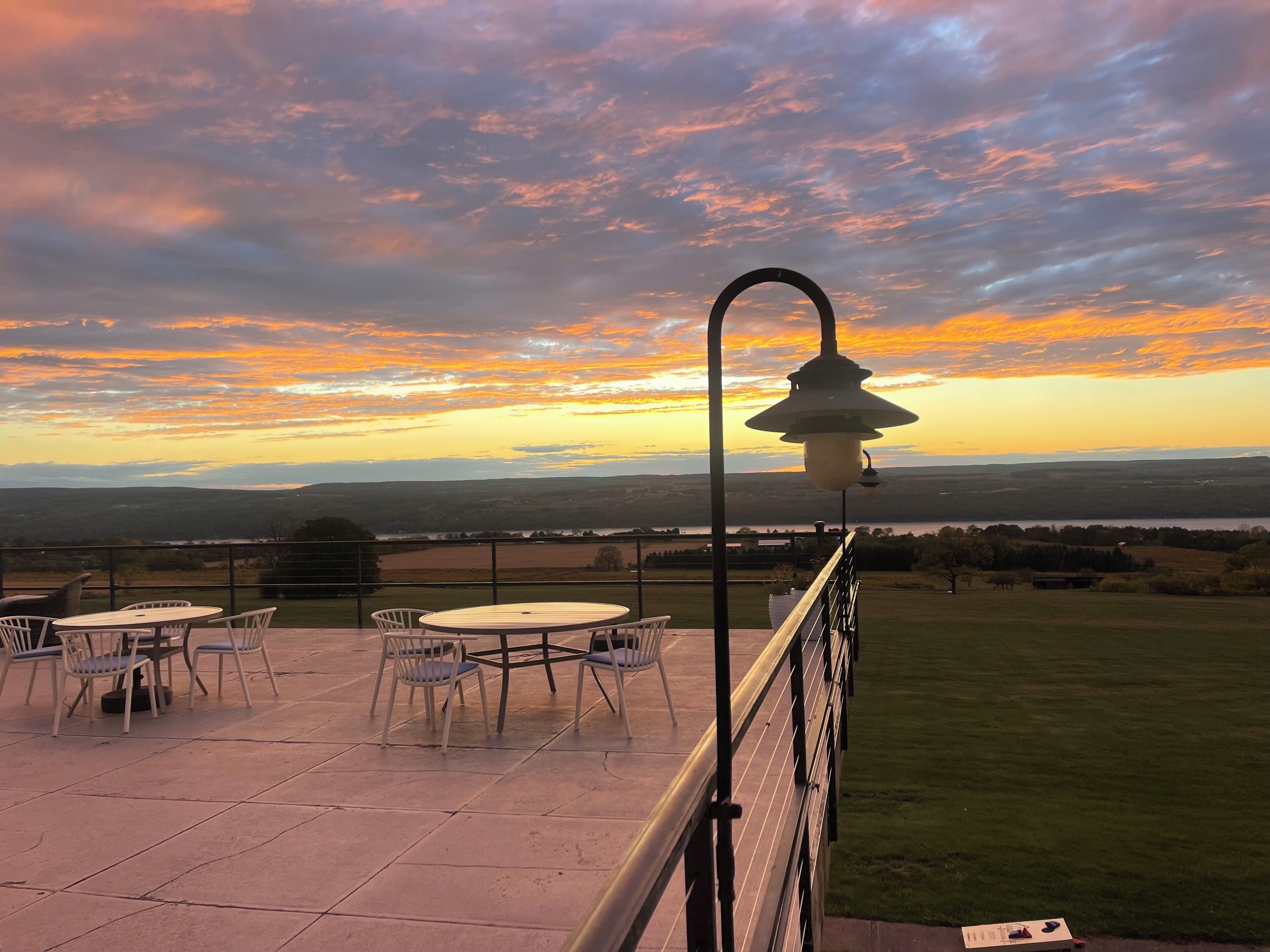 A terrace with outdoor seating and a view of the landscape.