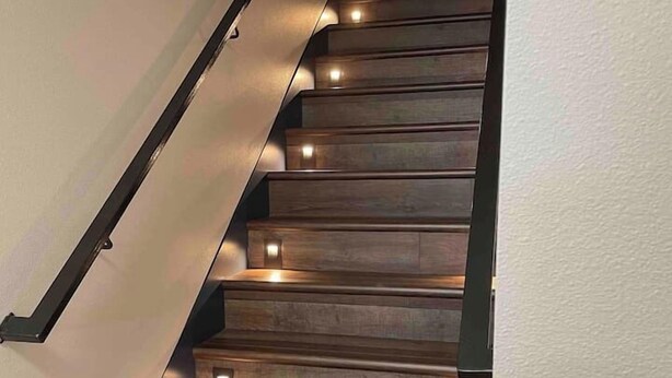 A wooden staircase with built-in lighting. - Werner Room 204, Hyland Hotel (Palmer)