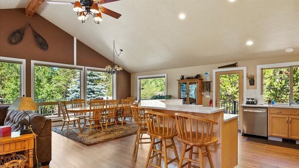 A spacious kitchen with a central island, wooden chairs, and a dining area. - Spacious 6-bedroom house in Sunriver perfect for families/groups (Sunriver)