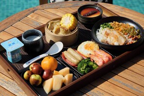 A tray with various foods including dumplings, corn, soup, and seafood. - PastForward Deer Luxury Hidden Retreat at Yulong River  (Guilin)