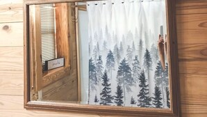 A wooden wall with a mirror reflecting a forest scene and a 'hello gorgeous' sign above it. - Cozy Bear Cabin - Log Cabin Soul, Nashville Heart (Nashville)