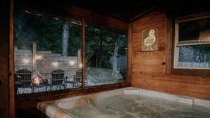 A wooden cabin with a hot tub, a deck with chairs, and a sign reading "CO-OP CHICKS". - Cozy Bear Cabin - Log Cabin Soul, Nashville Heart (Nashville)