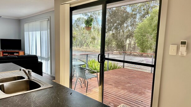 A modern kitchen with a large sliding glass door leading to an outdoor patio. - Among the Gums, Armagh, Clare Valley (Armagh)