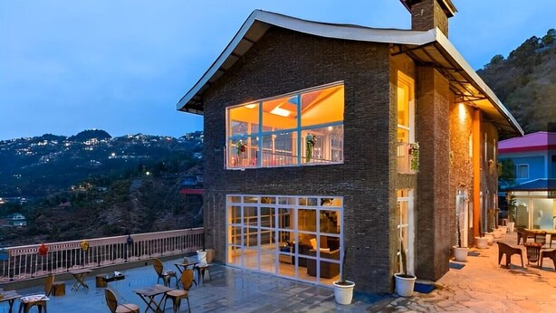 A two-story building with large windows and a balcony. - Pax & Opis Luxury Villa (Mussoorie)