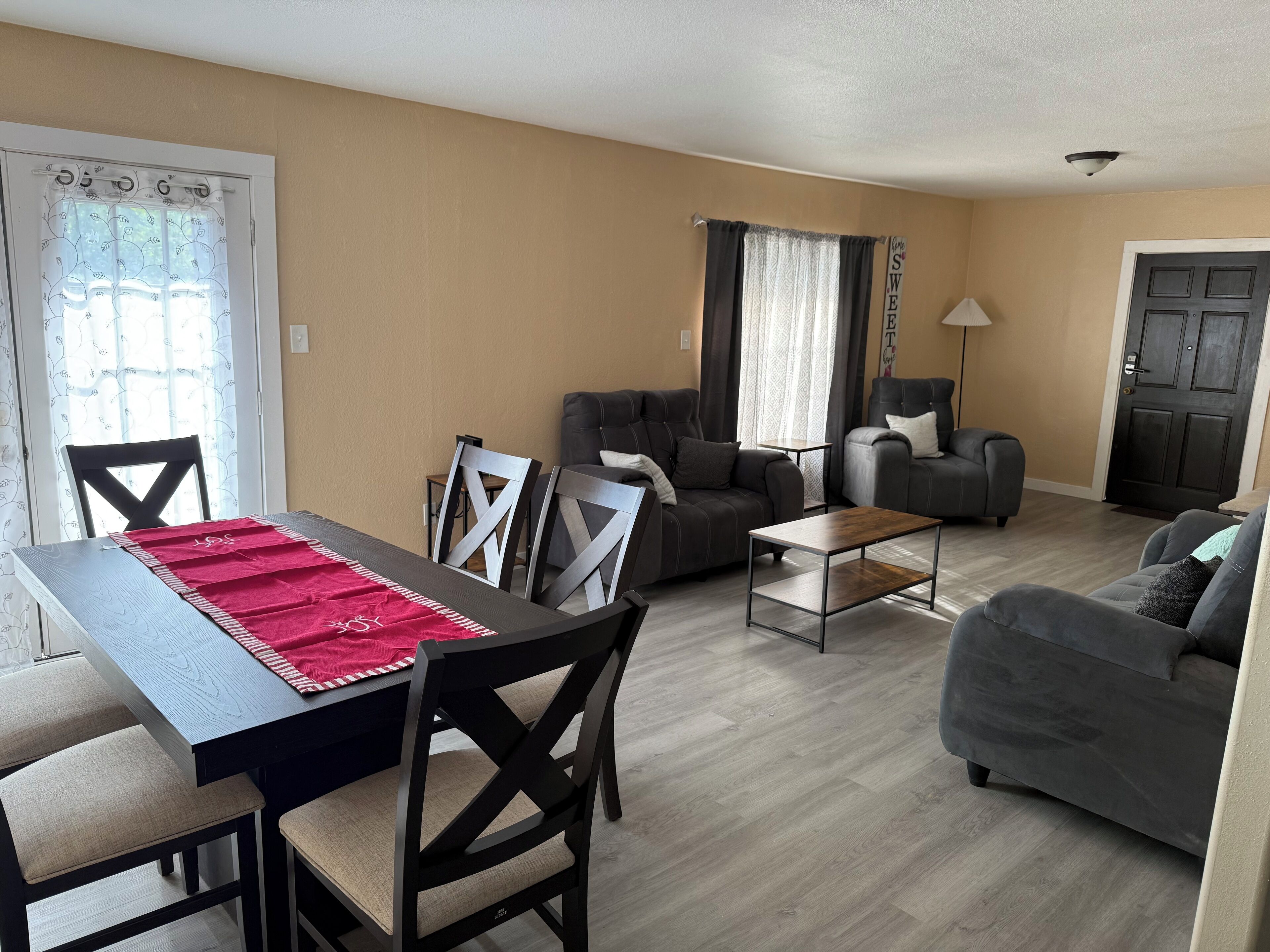 A living room with a dining table, two sofas, and a coffee table.