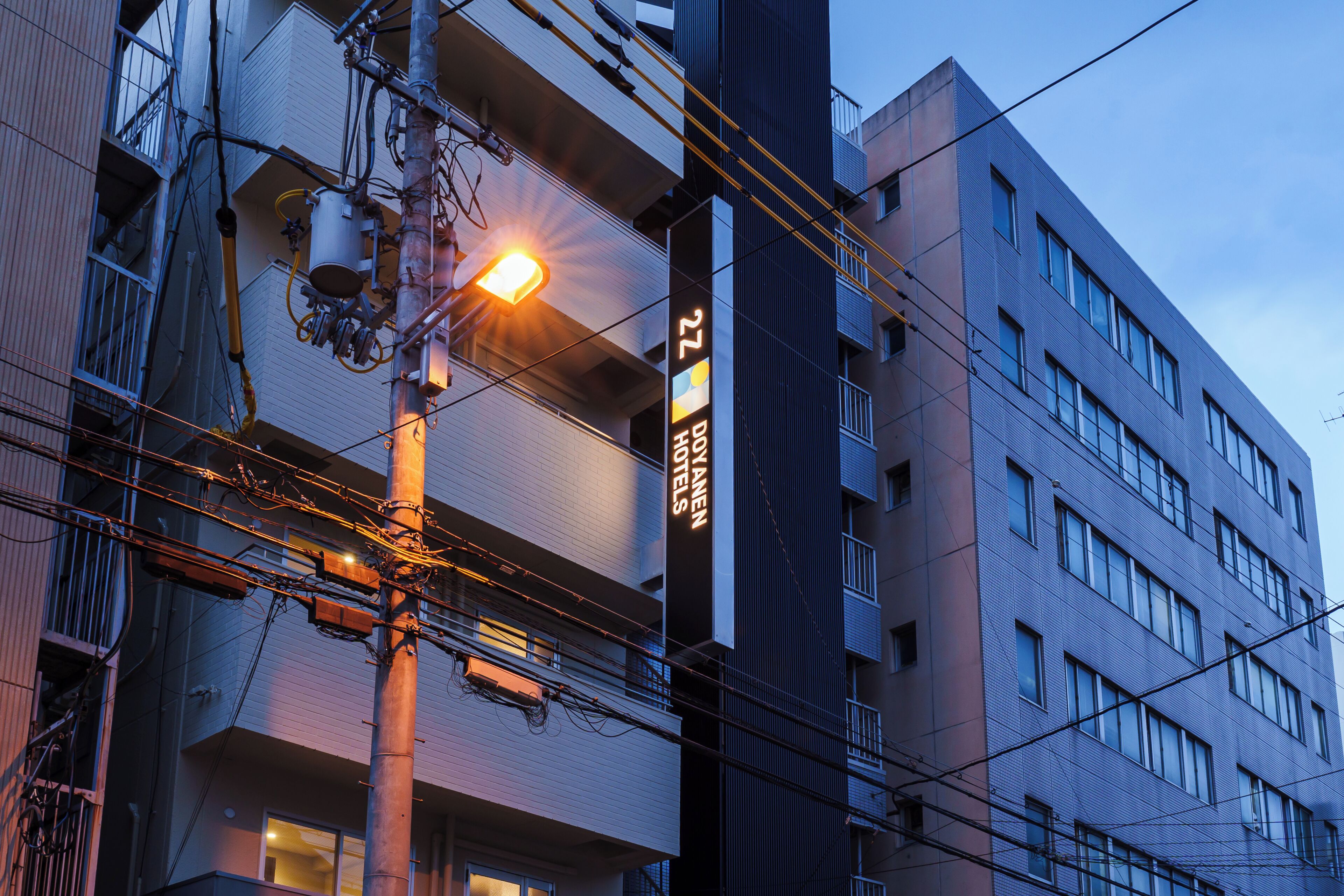 A multi-story building with a prominent sign indicating it is a hotel.