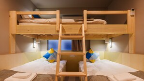 A bunk bed room with a ladder, two beds, and a window with curtains. - 2Z - DOYANEN HOTELS (Osaka)