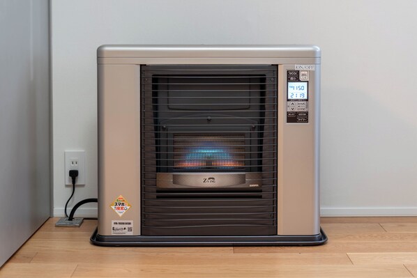 A portable electric heater with a control panel, brand name, and safety certification sticker.