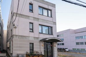 A multi-story building with a flat facade, large windows, and a covered entrance. - Mori ・Minutes walk to Sapporo Beer Museum・180 sq.m. (Sapporo, Higashi Ward)
